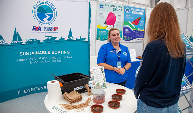 candid shot of two women talking about seed balls during an expo