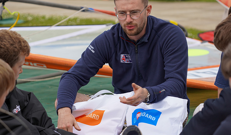 candid closeup of an instructor talking to a group children outside