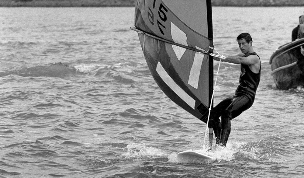 black and white image of King Charles windsurfing