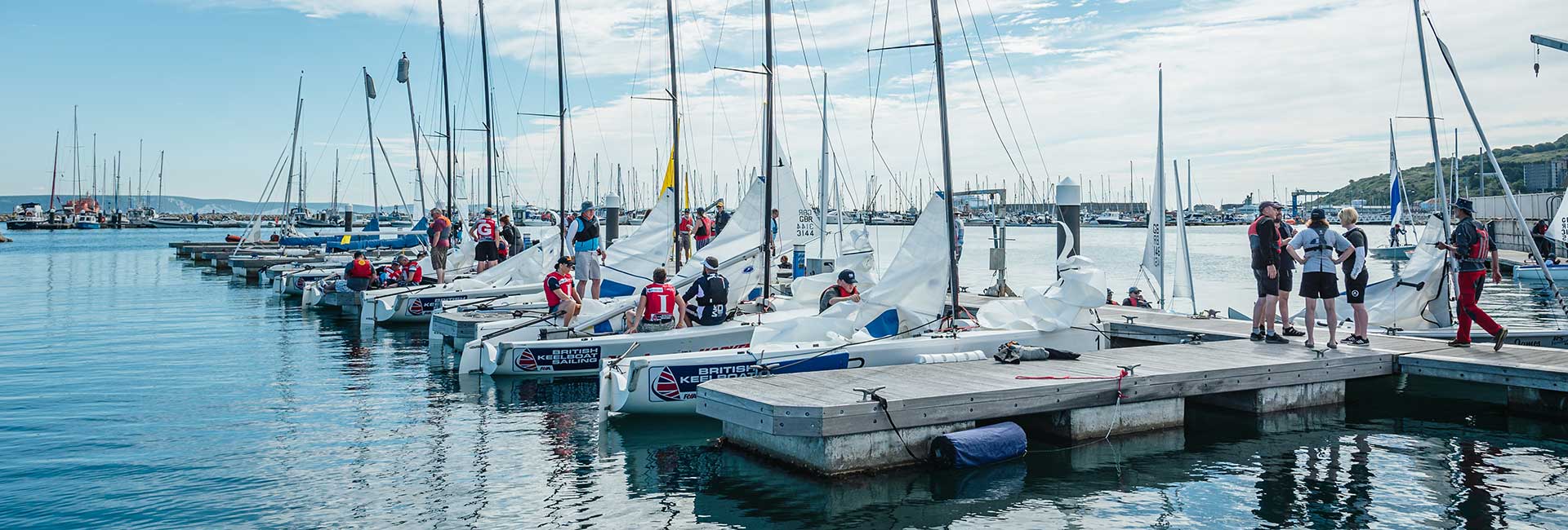 keelboat hero image of moored keelboats with a sailors talking 