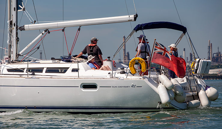 midshot of large yacht with people standing on the back