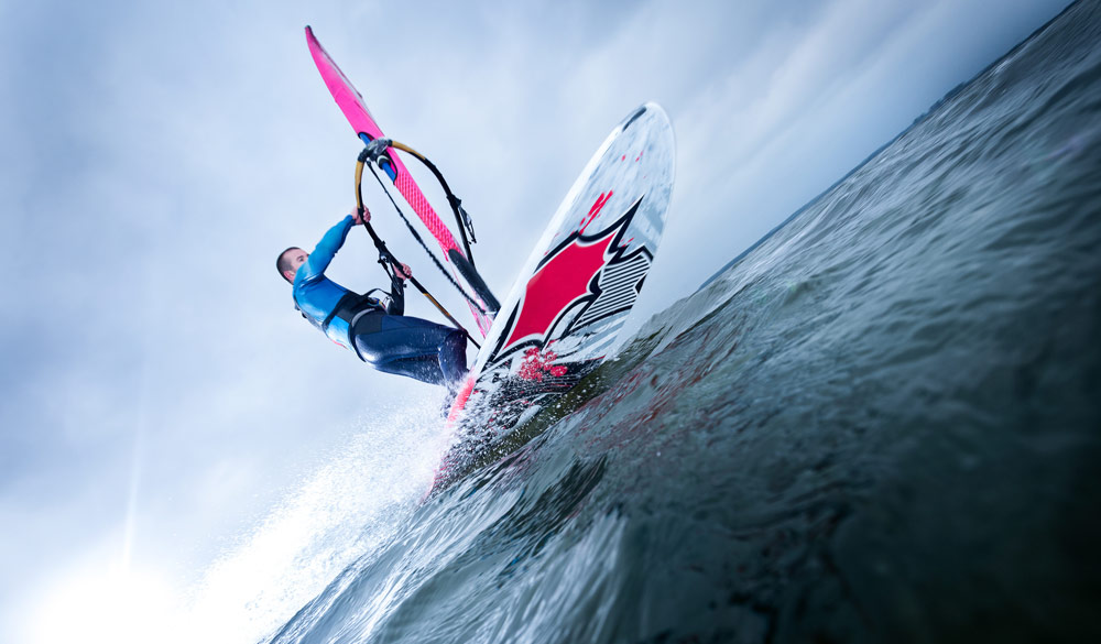 Windsurfer shot looking up from water