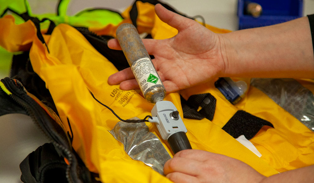 Tightening CO2 cannister during lifejacket servicing 