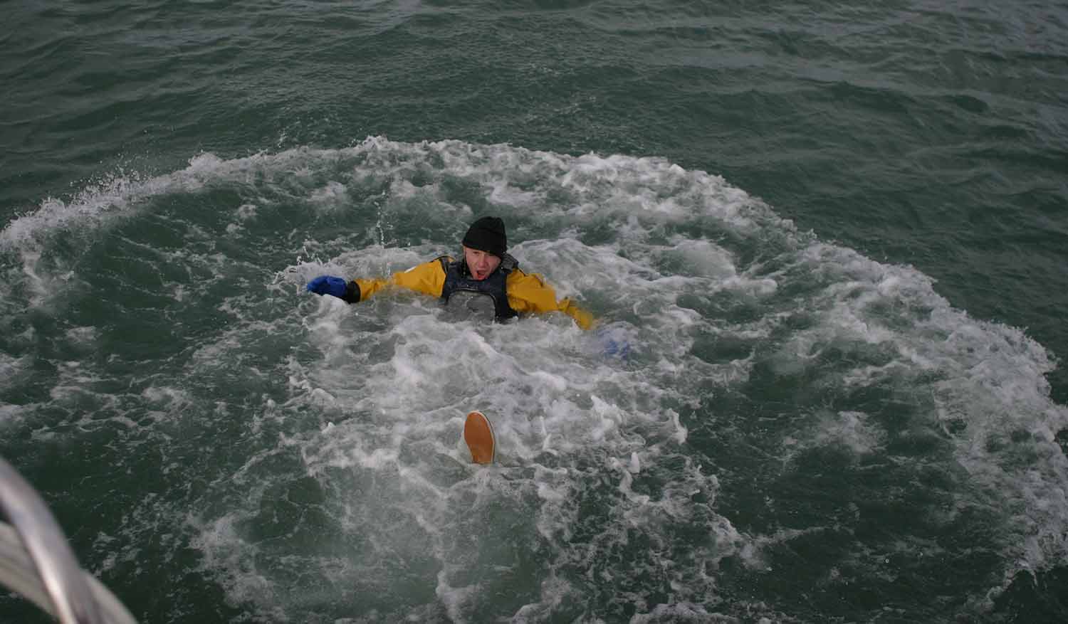 Wide shot of man who has fallen in the water