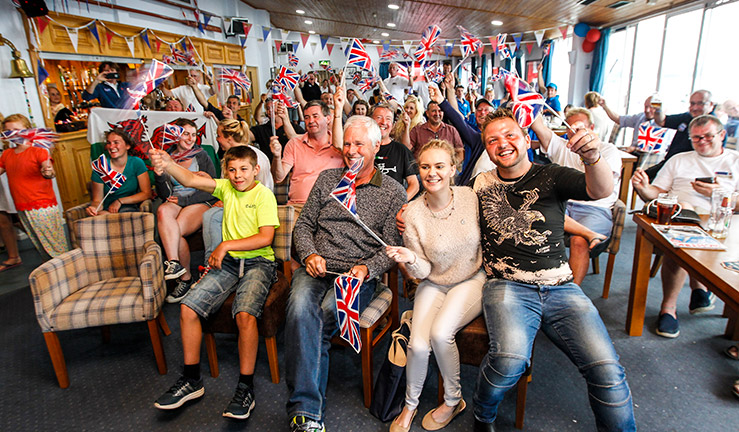 Sailing fans celebrating at an Olympic Watch Party