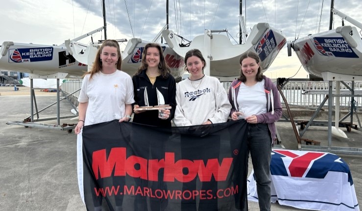 Juliette Kennedy's winning team of four with a trophy and holding a Marlow Ropes flag after claiming the RYA Marlow Ropes Women's Match Racing Championship 2024. 