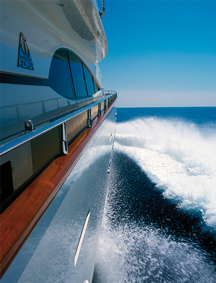 View from side deck of superyacht (motor) and wake on sunny calm day